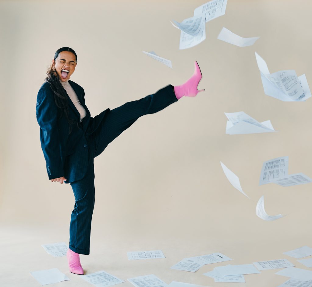 Person kicking paperwork to represent simplified compliance